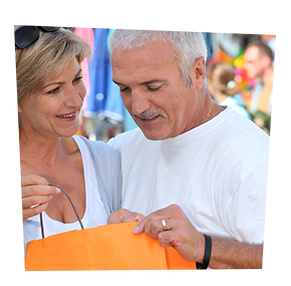 elder couple peeking into orange shopping bag